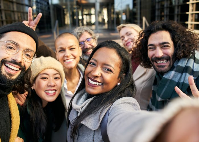 Selfie of a group of happy business people taking photo with a phone